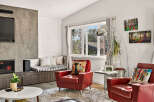 Experience modern living in this stylish living room, featuring a sleek fireplace and entertainment unit.
