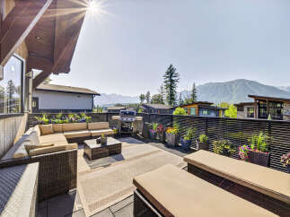 Enjoy breathtaking mountain views from this expansive outdoor living space, perfect for entertaining or relaxing.