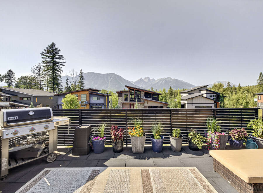 Enjoy breathtaking mountain views from this stunning modern home's expansive rooftop deck.