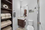 Discover this modern bathroom featuring a sleek vanity with a vessel sink and ample storage.