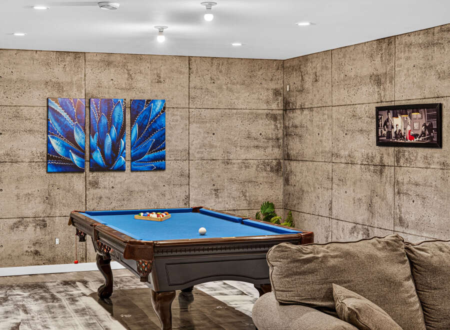 Experience ultimate relaxation in this stylish game room, featuring a professional billiard table perfect for friendly matches.