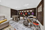 Unleash your inner rockstar in this ultimate entertainment room, complete with a foosball table and a fully equipped drum set.