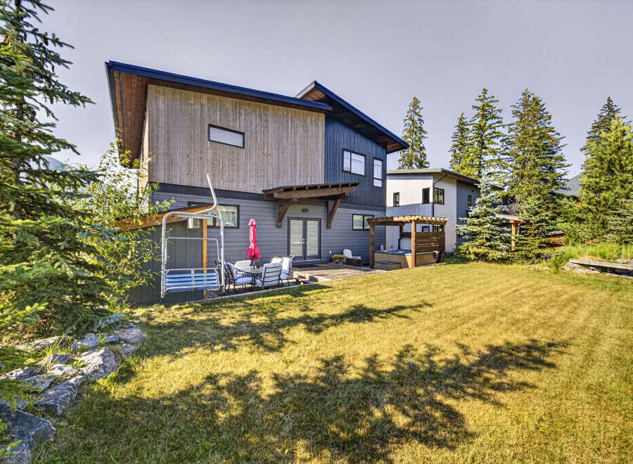 Experience luxury mountain living in this stunning modern home, featuring a private hot tub and spacious backyard perfect for entertaining.