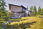 Experience luxury mountain living in this stunning modern home, featuring a private hot tub and spacious backyard perfect for entertaining.