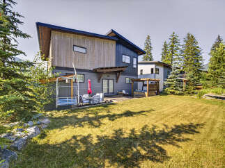 Experience luxury mountain living in this stunning modern home, featuring a private hot tub and spacious backyard perfect for entertaining.