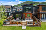 Experience modern mountain living in this stunning contemporary home, featuring a sleek design with wood and dark metal accents.