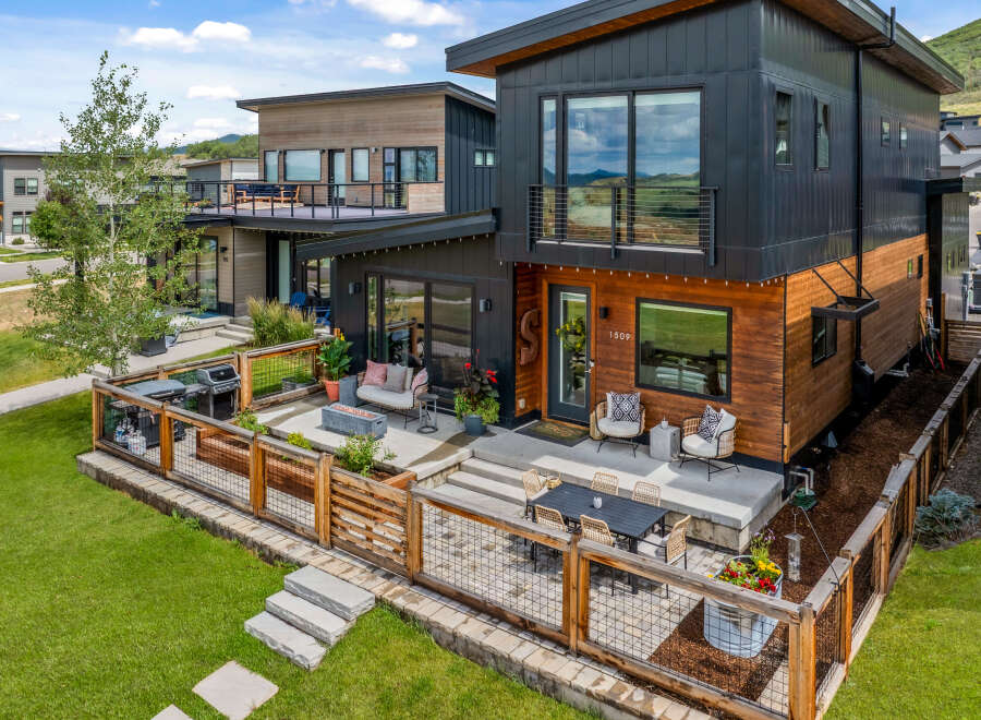 Experience modern living in this stunning multi-level home featuring a sleek black and wood exterior.