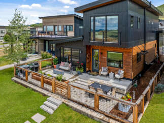 Experience modern living in this stunning multi-level home featuring a sleek black and wood exterior.