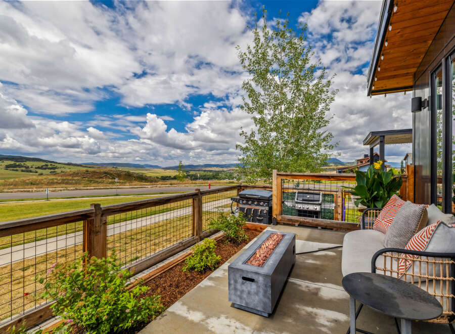 Experience breathtaking panoramic views from this stunning modern home's expansive patio.