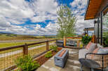 Experience breathtaking panoramic views from this stunning modern home's expansive patio.