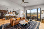 Experience modern living with this stunning open-concept space, featuring a sleek kitchen with a breakfast bar and a comfortable living area.
