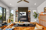 Experience modern living in this stunning living room featuring a sleek gas fireplace as the focal point, complemented by built-in shelving for a sophisticated display.