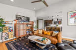 Experience modern living in this stylish open-concept space, featuring a sleek leather sofa and a marble-topped coffee table perfect for entertaining.