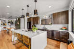 Experience modern living in this stunning kitchen featuring a large island with bar seating, perfect for entertaining.