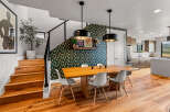 Experience modern living in this stunning home featuring a chic dining area with a statement wallpaper and pendant lights.