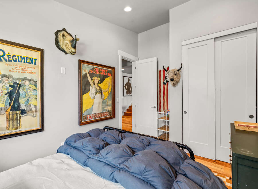 This eclectic bedroom features a unique blend of vintage charm and bold decor.