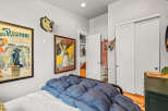 This eclectic bedroom features a unique blend of vintage charm and bold decor.
