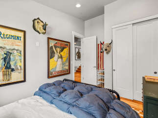 This eclectic bedroom features a unique blend of vintage charm and bold decor.