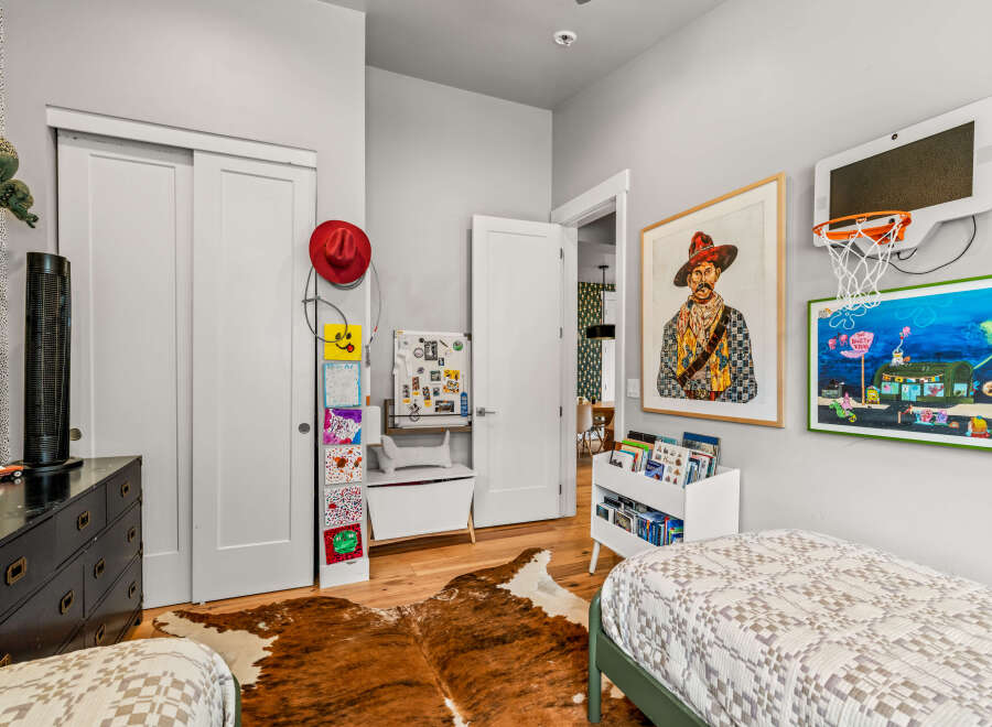 This charming bedroom is perfect for a child, featuring two cozy beds and playful decor.