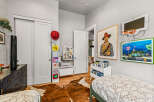 This charming bedroom is perfect for a child, featuring two cozy beds and playful decor.