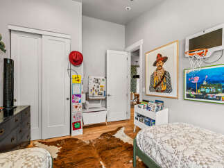 This charming bedroom is perfect for a child, featuring two cozy beds and playful decor.