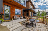 Experience modern living in this stunning home featuring a warm wood exterior and a welcoming front porch.