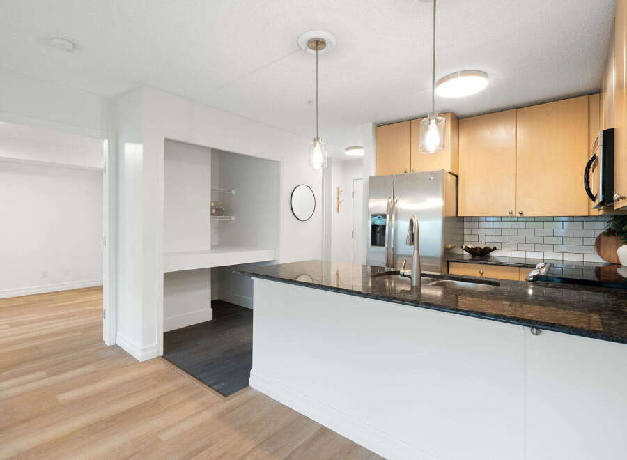 Discover this modern kitchen featuring sleek granite countertops and a spacious island perfect for entertaining.