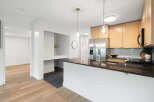 Discover this modern kitchen featuring sleek granite countertops and a spacious island perfect for entertaining.
