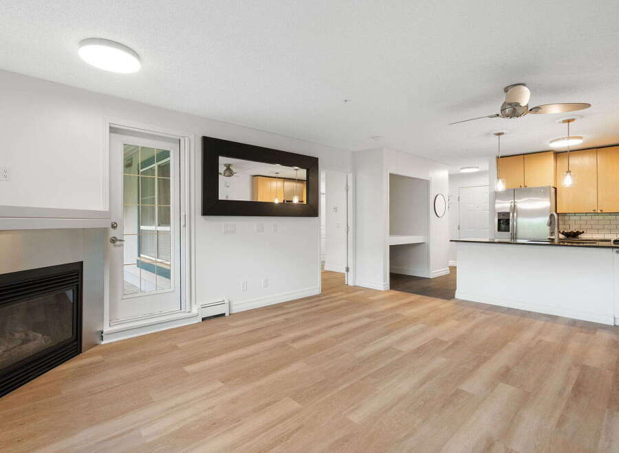 Experience modern living in this beautifully appointed condo featuring a sleek gas fireplace and a bright, open-concept living space.
