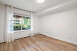 Bright and airy, this room features a large window with sheer curtains, offering ample natural light.