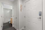 Step into this inviting entryway featuring a sleek smart lock on the front door for enhanced security.
