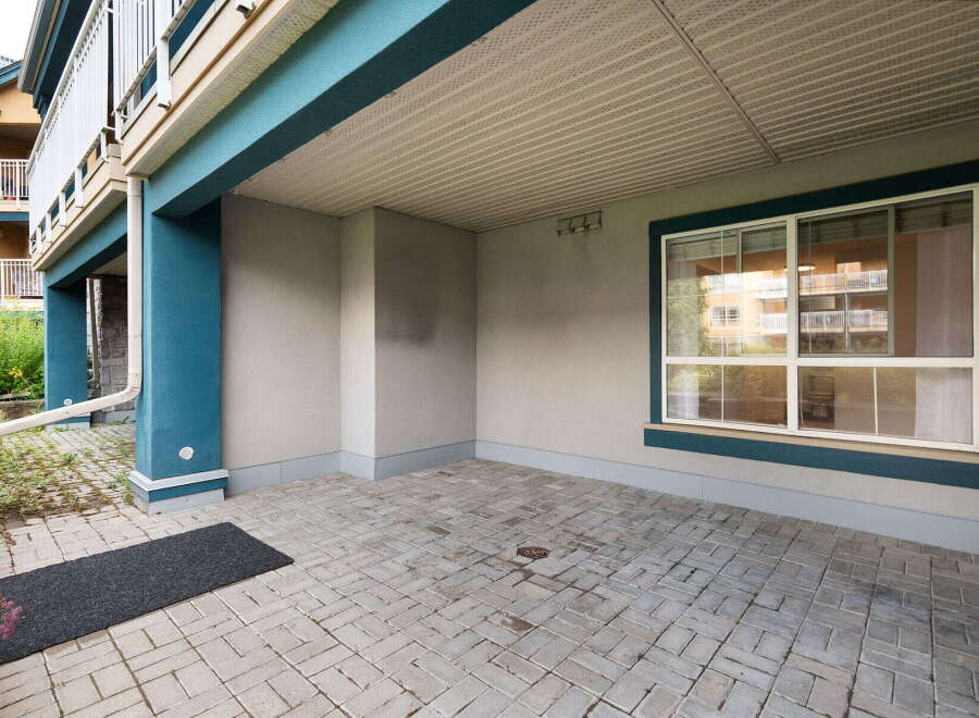 Discover this charming covered patio area, perfect for outdoor relaxation and entertaining.