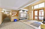 Welcome to this inviting building lobby, featuring a long, well-lit hallway and a convenient mail area with secure mailboxes.