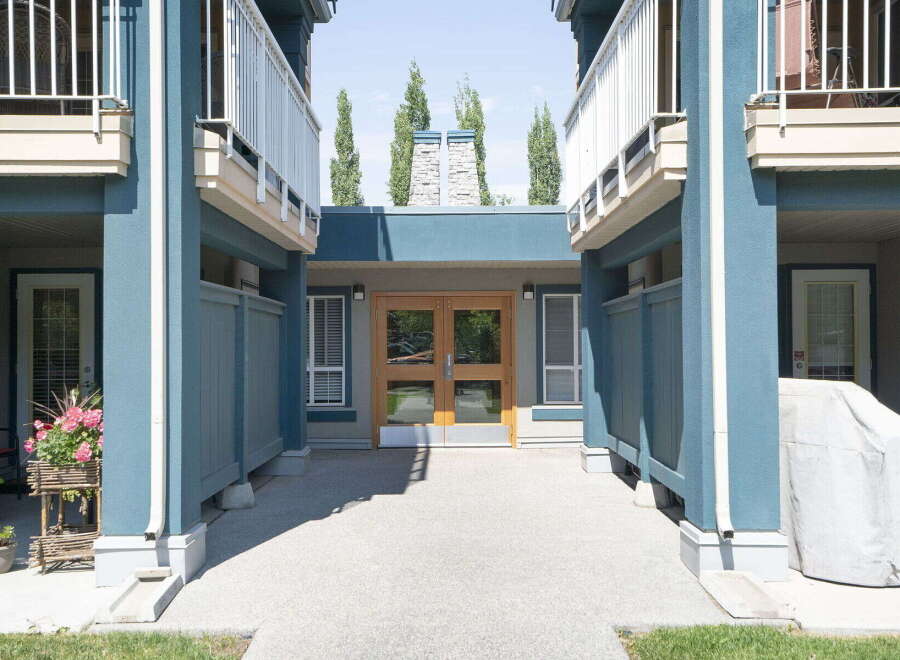 Discover modern living in this stunning property featuring a welcoming entrance with double glass doors and elegant blue exterior accents.