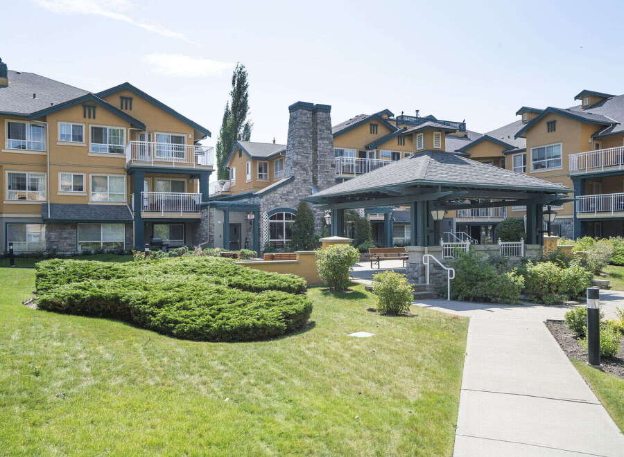 Discover comfortable living in this well-maintained apartment complex, featuring a charming gazebo and lush green spaces perfect for relaxation.