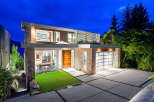 Experience modern luxury in this stunning architectural home, featuring a striking stone and wood facade.
