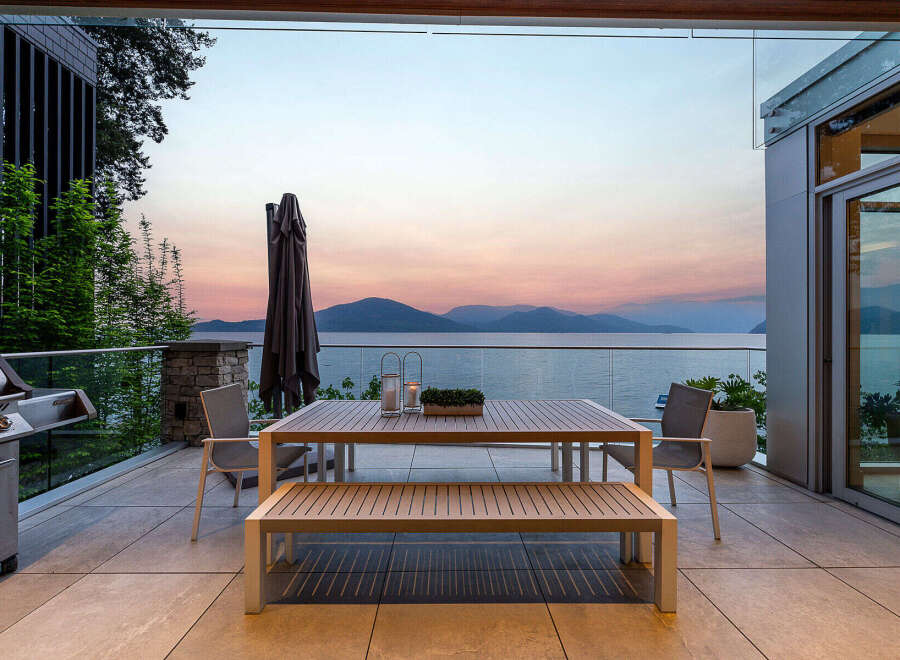 Experience breathtaking sunset views over the water from this stunning outdoor dining area.