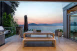 Experience breathtaking sunset views over the water from this stunning outdoor dining area.