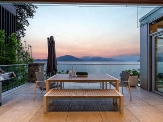 Experience breathtaking sunset views over the water from this stunning outdoor dining area.