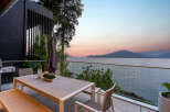Experience breathtaking sunset views from this modern home's expansive outdoor living space.