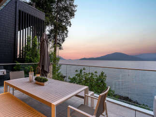 Experience breathtaking sunset views from this modern home's expansive outdoor living space.