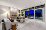 Experience luxurious living in this modern home featuring a stunning fireplace with blue flames and a spacious open-concept living area.