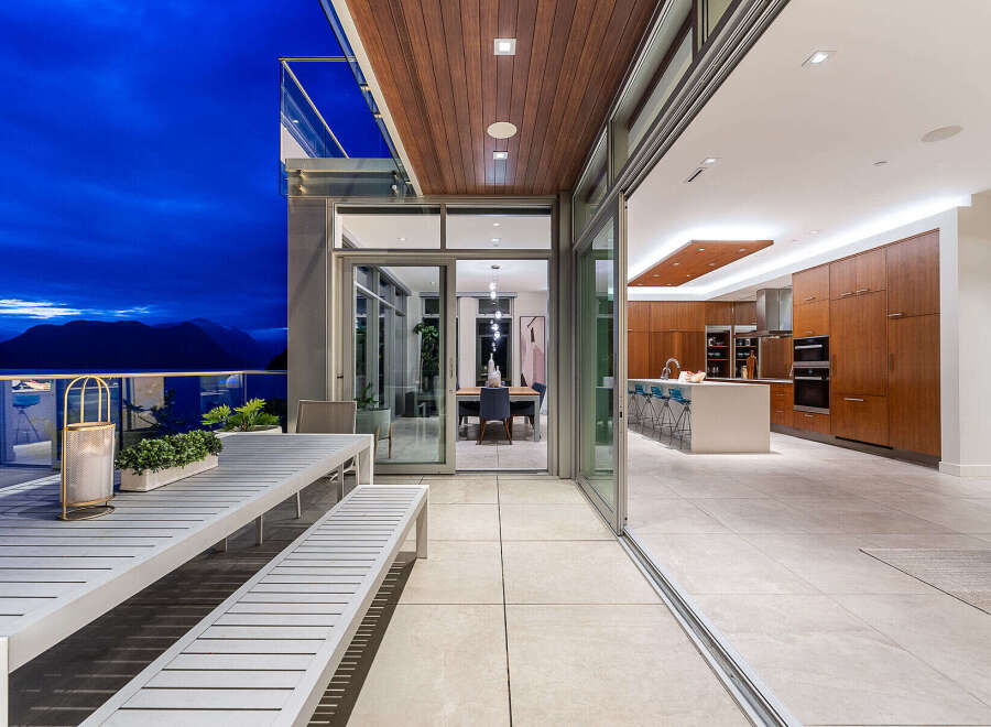 Experience luxurious indoor-outdoor living with this stunning property, featuring a spacious patio overlooking a breathtaking mountain and ocean view.