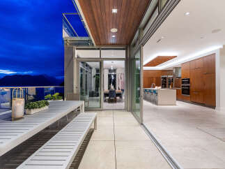 Experience luxurious indoor-outdoor living with this stunning property, featuring a spacious patio overlooking a breathtaking mountain and ocean view.
