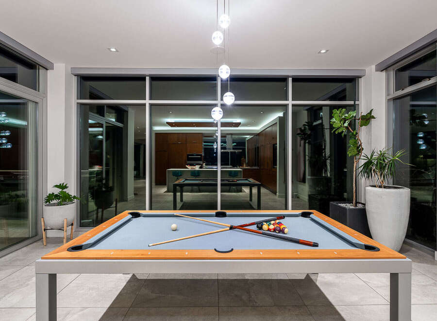 Experience luxury living with this stunning modern home featuring an indoor/outdoor entertainment space.