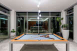 Experience luxury living with this stunning modern home featuring an indoor/outdoor entertainment space.