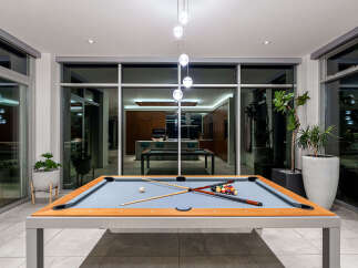 Experience luxury living with this stunning modern home featuring an indoor/outdoor entertainment space.