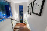Experience modern living with this stunning staircase featuring a sleek glass railing and rich hardwood treads.