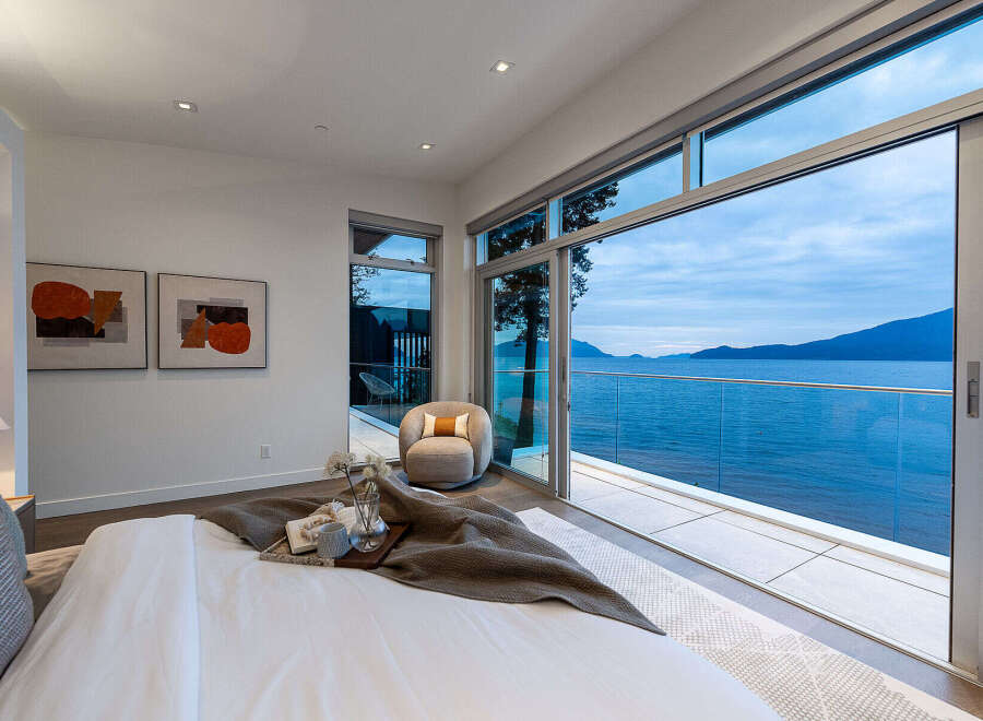 Experience breathtaking ocean views from this luxurious bedroom, featuring a spacious king-sized bed and a private balcony perfect for enjoying the serene coastal scenery.