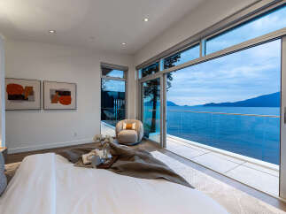 Experience breathtaking ocean views from this luxurious bedroom, featuring a spacious king-sized bed and a private balcony perfect for enjoying the serene coastal scenery.